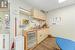 Kitchen featuring sink, cream cabinetry, light hardwood / wood-style floors, and a drop ceiling