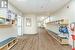 Corridor featuring light wood-type flooring and a paneled ceiling