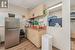 Kitchen featuring a paneled ceiling, sink, stainless steel fridge, light wood-type flooring, and light brown cabinetry