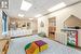 Bedroom featuring white fridge, a drop ceiling, and light hardwood / wood-style floors