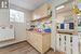 Kitchen with sink, a drop ceiling, light brown cabinets, and light wood-type flooring