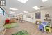 Recreation room featuring a drop ceiling and light wood-type flooring