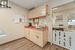 Kitchen featuring light brown cabinetry, a paneled ceiling, light hardwood / wood-style floors, and sink