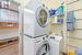 Washroom featuring cabinets, light wood-type flooring, sink, and stacked washer and clothes dryer