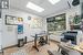 Office with a paneled ceiling and light wood-type flooring