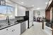 Kitchen featuring sink, appliances with stainless steel finishes, tasteful backsplash, light hardwood / wood-style floors, and white cabinetry