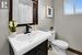 Bathroom with vanity, hardwood / wood-style flooring, and toilet