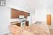 Kitchen with white appliances, sink, crown molding, light wood-type flooring, and kitchen peninsula