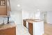 Kitchen featuring sink, ornamental molding, white appliances, and light wood-type flooring