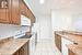 Kitchen with light tile patterned floors, white appliances, and sink