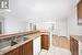 Kitchen featuring white dishwasher, light hardwood / wood-style flooring, ornamental molding, and sink