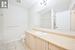 Bathroom featuring tile patterned flooring, vanity, and toilet