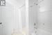 Bathroom with tile patterned flooring and shower / bath combo