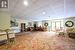 Living room with a paneled ceiling, french doors, and carpet floors