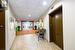 Hall featuring a drop ceiling, light tile patterned flooring, and elevator