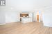 Unfurnished living room with light hardwood / wood-style floors and crown molding