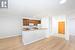 Kitchen with kitchen peninsula, white appliances, light hardwood / wood-style floors, and crown molding