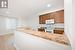 Kitchen featuring light wood-type flooring, white appliances, and crown molding