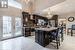 Kitchen with appliances with stainless steel finishes, an inviting chandelier, a kitchen island, and a wealth of natural light