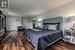 Bedroom featuring dark wood-type flooring and two closets