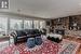 Living room featuring hardwood / wood-style floors, crown molding, a brick fireplace, and a textured ceiling