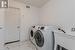 Laundry area with washing machine and dryer and sink