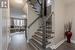 Stairway featuring a textured ceiling and hardwood / wood-style flooring