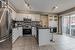 Kitchen featuring a kitchen bar, kitchen peninsula, white cabinetry, and appliances with stainless steel finishes