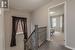 Corridor with carpet flooring, a textured ceiling, and plenty of natural light