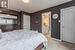 Carpeted bedroom featuring a textured ceiling and ensuite bathroom