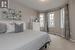 Bedroom with a textured ceiling and light colored carpet