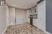 Bar featuring wine cooler, light hardwood / wood-style floors, white cabinetry, and fridge