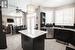 Kitchen with a center island, sink, stainless steel dishwasher, backsplash, and decorative light fixtures