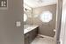 Bathroom featuring tile patterned floors, vanity, a healthy amount of sunlight, and toilet