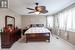 Carpeted bedroom featuring ceiling fan and a textured ceiling