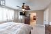 Bedroom featuring a textured ceiling, ceiling fan, and light carpet