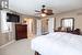 Carpeted bedroom featuring ceiling fan