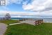 View of home's community featuring a water view and a yard