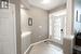 Foyer featuring light tile patterned floors and decorative columns