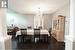 Dining space featuring dark hardwood / wood-style flooring, an inviting chandelier, and ornate columns