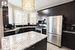 Kitchen featuring sink, a notable chandelier, backsplash, light tile patterned floors, and black appliances