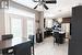 Dining room with light tile patterned floors, ceiling fan with notable chandelier, and plenty of natural light