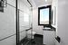 Bathroom with tiled shower, vanity, and toilet