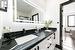 Bathroom featuring a shower, vanity, and porcelain tile patterned flooring