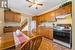 Kitchen featuring white appliances, ceiling fan, crown molding, and sink