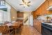 Kitchen featuring white refrigerator, sink, crown molding, ceiling fan, and gas stove