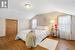 Bedroom featuring hardwood / wood-style flooring and lofted ceiling