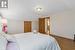 Bedroom featuring hardwood / wood-style flooring and vaulted ceiling