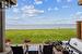 View of yard with an outdoor hangout area, a water view, a patio, and a beach view