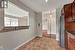 Kitchen featuring pendant lighting, light tile patterned floors, dark stone counters, and stainless steel refrigerator